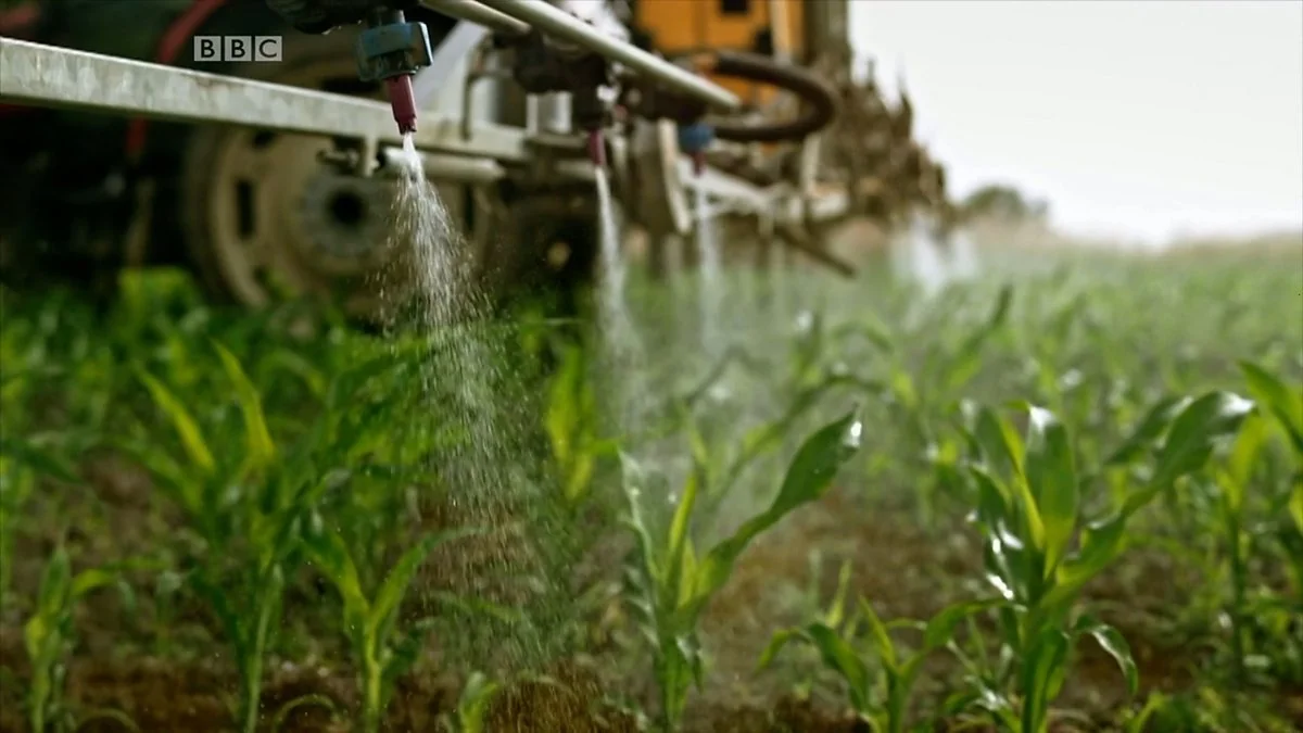 Crop-spraying equipment above a green field in the BBC report